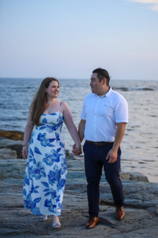 Couple walking by the ocean.