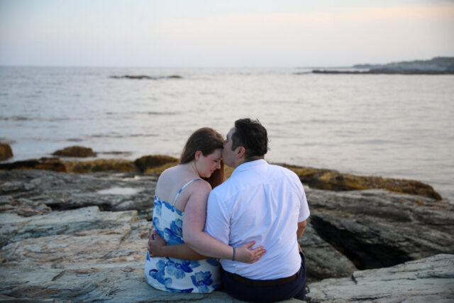 Couple embracing by the ocean.
