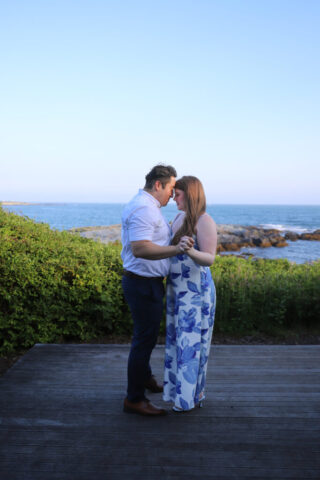Couple dancing by the ocean.